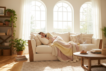 brighten up the picture a person snuggled up on a sofa in blankets