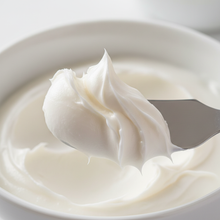 Close-up of thick shea butter lotion being scooped