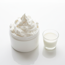 Overhead view of extra fluffy goat milk lotion piled high with milk